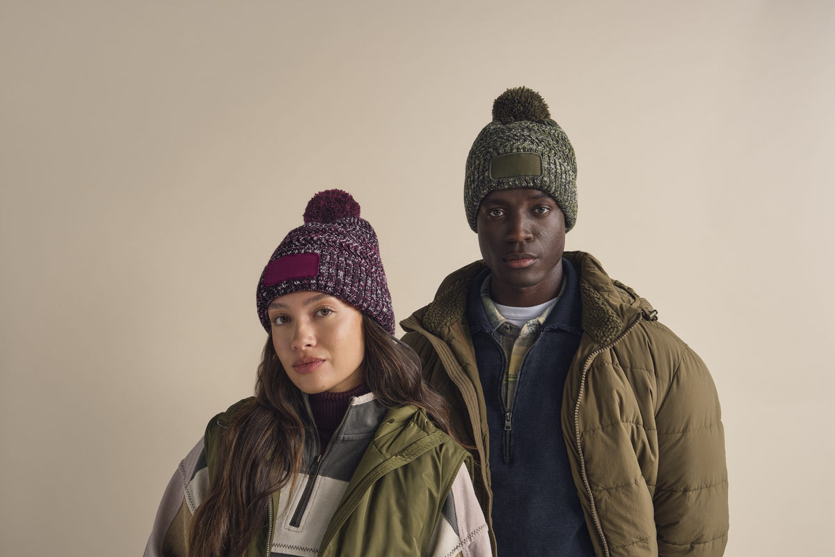 Two people wearing Beechfield twist knit bobble beanies