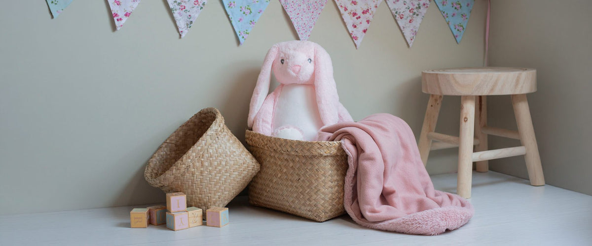 Mumbles soft toy bunny and blanket in a nursery setting